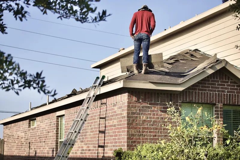 Professional roofer working on a residential roof in Golf and Sea Village of Apollo Beach